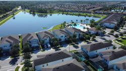 Experience tranquil views from your vacation home, where lush greenery meets serene water reflections. The inviting outdoor space features well-maintained landscaping, perfect for relaxation or enjoying a meal al fresco.