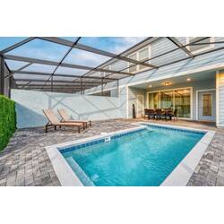 Step outside to your private oasis with a refreshing pool surrounded by elegant pavers and cozy seating. Relax on stylish loungers or enjoy al fresco meals at the dining table during sunny afternoons.