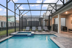 Step outside to your private oasis with a sparkling pool and soothing spa in a screened enclosure. Relax on the inviting lounge chairs and enjoy the bright, airy atmosphere for a perfect outdoor experience.