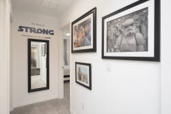 You’ll be welcomed by a stylish hallway adorned with chic decor and framed black-and-white photography, creating a bright and airy atmosphere. Cleverly placed mirrors amplify the light, making the space feel even more inviting.