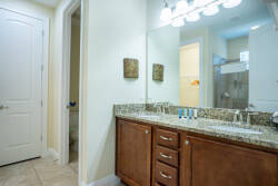 Experience a beautifully designed bathroom with a dark wood vanity and elegant granite, combining style and practicality. Bright lighting and neutral tones create a refreshing ambiance, enhancing your self-care routine.