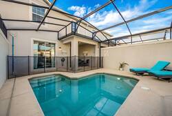 Step into your private oasis, featuring a sparkling pool framed by a sleek, screened enclosure. Enjoy the soothing ambiance with contemporary lounge chairs and a backdrop of inviting natural light filtering through.