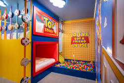 Step into a vibrant kids' playroom filled with playful colors and whimsical decor inspired by a beloved animated classic. The cozy nook with a soft mattress invites relaxation, while the colorful ball pit sparks joy and adventure.