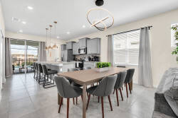 Enjoy our bright dining area with a sleek wooden table and stylish gray chairs, ideal for gatherings. The modern kitchen boasts clean lines and contemporary finishes, inspiring culinary creativity and memorable meals with loved.
