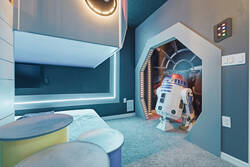 Rest in a futuristic space themed bedroom with a cozy bed, spaceship wall mural, soft LED lighting, colorful decor, and playful loft details, creating a fun space for kids during vacation.