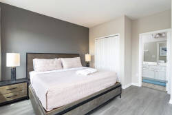 Experience comfort in this inviting bedroom, featuring a spacious king bed with soft linens, stylish nightstands, and modern lamps.