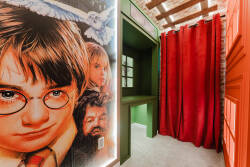 Enter a whimsical world in this vibrant entryway, adorned with a nostalgic mural of iconic characters. Bold red curtains and rich green accents create an immersive atmosphere, ensuring every arrival feels like a grand entrance.