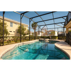 Enjoy a sunny private screened pool with a raised spa, lounge chairs, and peaceful neighborhood views. The bright enclosure and open patio create a relaxing outdoor space for swimming, resting, and enjoying Florida weather