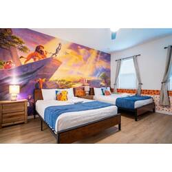 Rest in a bright safari-themed bedroom with two cozy beds, blue accents, wood furniture, and a colorful savanna mural. Natural light, soft bedding, and playful details create a fun and comfortable space for kids or family guests.