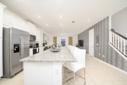 Welcome to this spacious kitchen with stainless steel appliances and a beautiful granite countertop, ideal for culinary adventures.