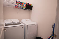 Experience the convenience of our modern laundry room, complete with efficient washers and dryers, plus neatly organized colorful towels, ensuring your stay is effortless and enjoyable.