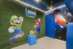 Enter a lively game room featuring giant Mario and Luigi murals that energize the space. With playful blue and green accents and soft grass-like textures, it’s the perfect spot for fun and creativity for guests of all ages.