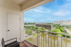 Step onto your private balcony to take in stunning views of lush greenery and tranquil waters. The sleek metal railing and cozy chair invite you to relax and savor the fresh air and vibrant atmosphere.