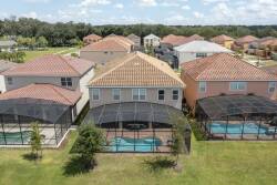 Enjoy sunny days by your private pool in a beautifully landscaped backyard, complete with a spacious patio and elegant screening. The vibrant terracotta roofs and lush greenery offer a perfect setting for relaxation.