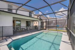 Welcome to your private oasis, featuring a shimmering pool shielded by a protective screen for your comfort. The spacious outdoor area is perfect for lounging in the sun and soaking up the serene atmosphere. Enjoy your stay!