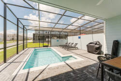 Step outside to your private pool area, featuring a screened enclosure for comfort and privacy. With stylish lounge chairs and a shaded dining area, it’s the perfect spot to soak up the sun or relax with friends.