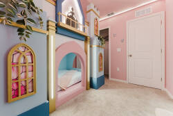 Enter a whimsical space with charming pastel walls and colorful windows. This cozy nook invites relaxation, and the soft carpet adds warmth, creating an enchanting spot perfect for guests of all ages to unwind and enjoy.