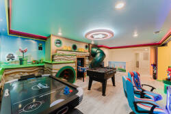 Experience our vibrant game room, complete with a colorful air hockey table and foosball for friendly competition. Lively murals and bright lighting create an energetic atmosphere ideal for family fun and entertainment.