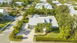 Tucked away in lush greenery, this lovely rental features a welcoming exterior, a spacious driveway, and vibrant palm trees. Relax in your private outdoor space and enjoy the tranquility of the peaceful neighborhood around you.