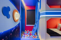 Discover a vibrant space brimming with playful colors and imaginative designs that inspire joy. Cozy bunk beds in bright blue and red set a fun tone, while the colorful ball pit encourages laughter and creativity for all.