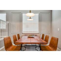 Join us at the rustic wooden dining table, surrounded by chic leather chairs and warmed by soft natural light. The sleek pendant light adds a modern flair, ensuring every meal feels like a special occasion.