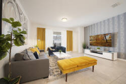 Relax in our bright living room, where a cozy gray sofa with cheerful yellow accents creates a welcoming vibe. The stylish patterned rug and elegant wall decor add a contemporary touch, perfect for unwinding after your adventures.